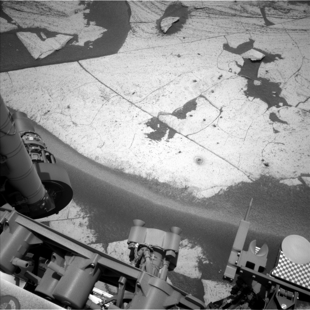 Enlarged Left Navcam view of the Basque Lakes drill hole and tailings, with Curiosity rover hardware visible below.